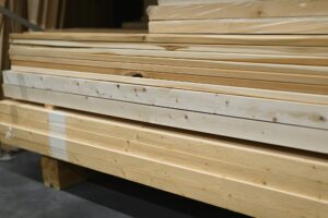 Wooden bar in hardware store. Treated wood panels at sawmill wholesale warehouse